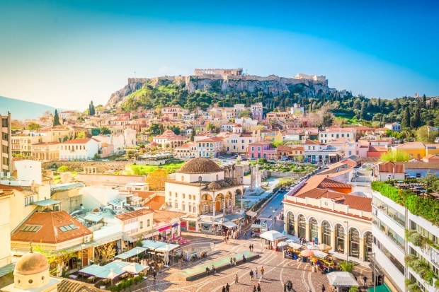 an aerial view of a city with a castle in the background