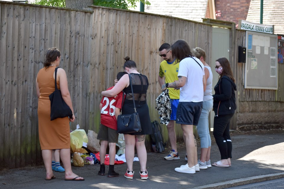 His son Lee, seen here in the yellow top, laid a wreath for his dad earlier today