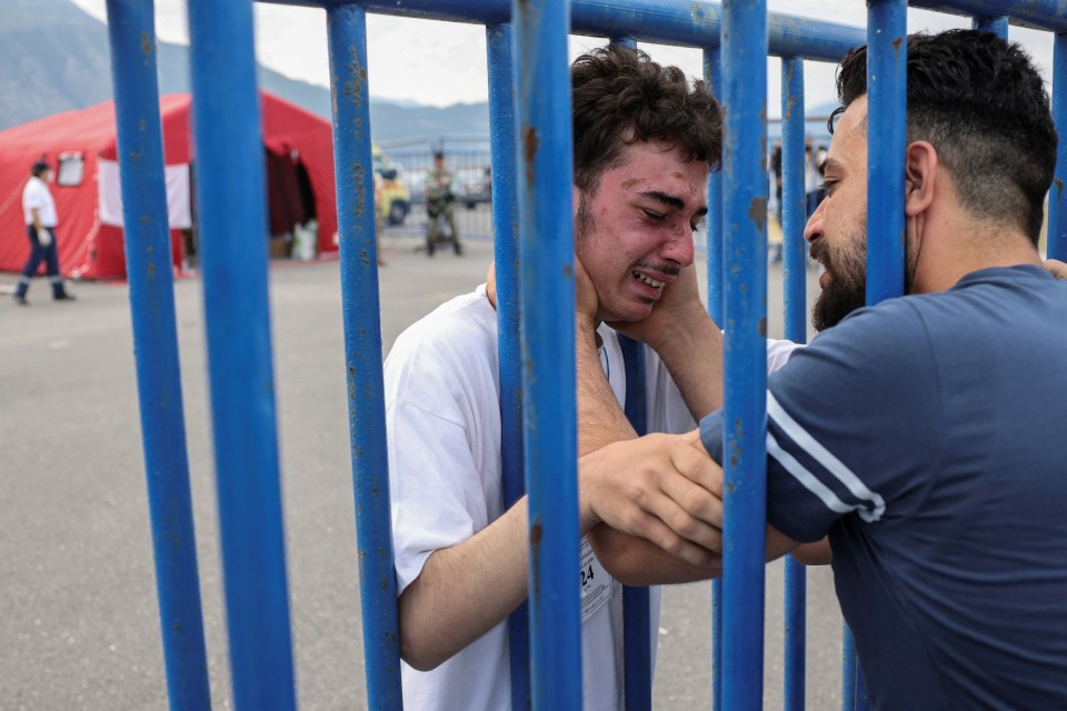 Syrian survivor Fedi, 18, cries as he reunites with his brother Mohammad, who came to meet him from Italy