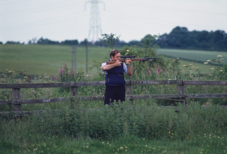 Prudom hid out in fields while on the run. Pictured, a cop on the lookout