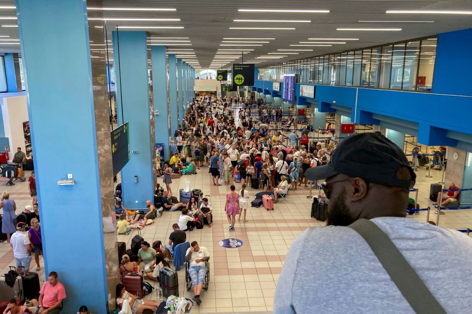 People wait in the airport in the hopes of catching a plane out