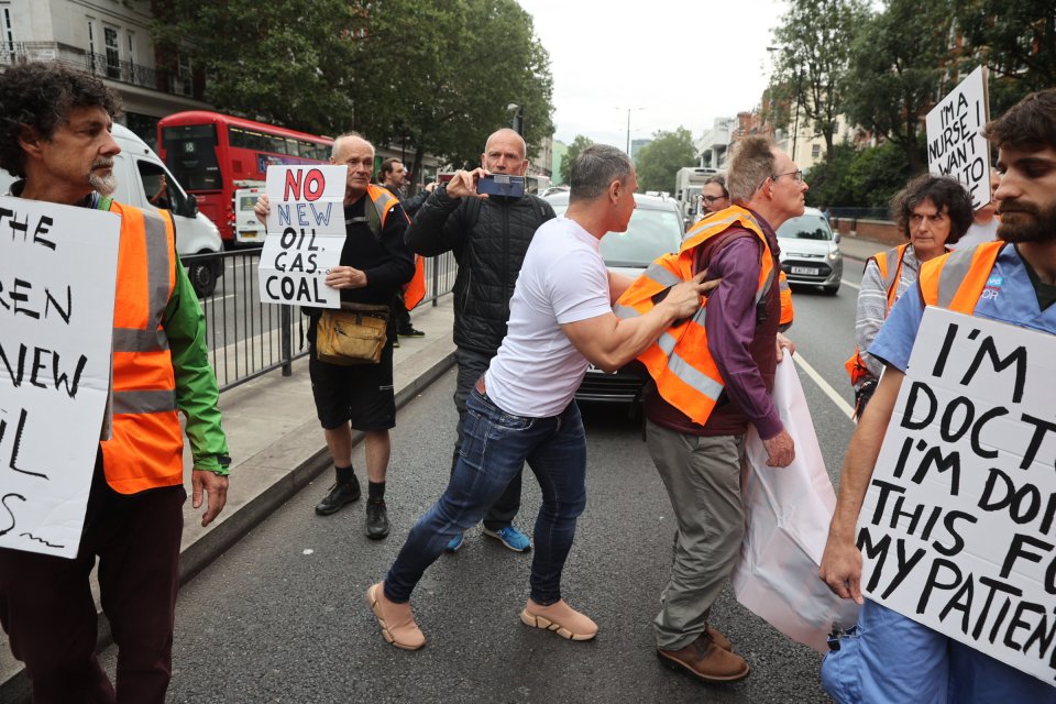 Another motorist tried to move the shuffling group on, too