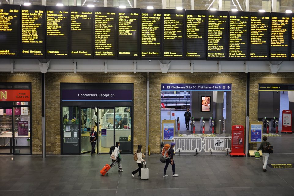 Travellers wait for trains in a quiet King,s Cross Station during strike action by the RMT union