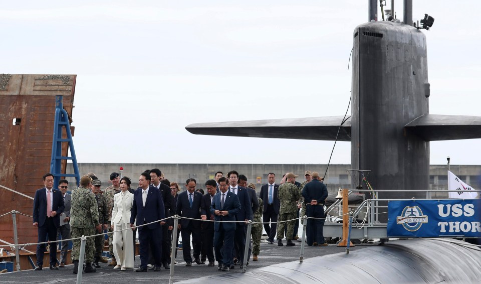 South Korean President Yoon Suk Yeol boards the USS Kentucky at Busan naval base yesterday