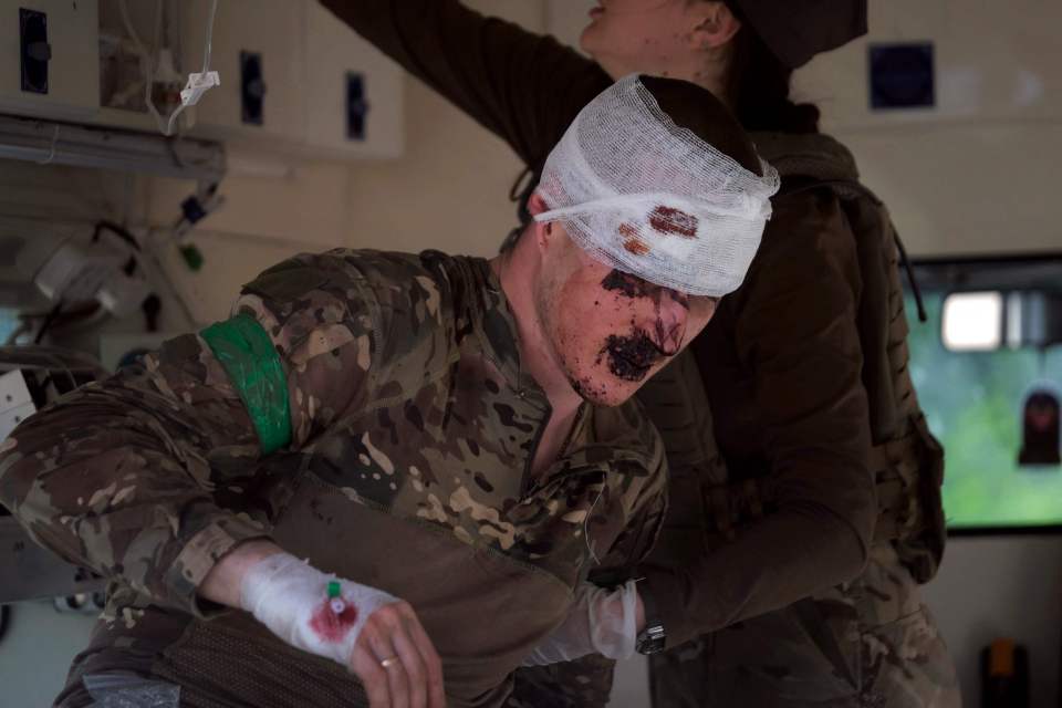 A wounded Ukrainian serviceman receives treatment during the battle of Bakhmut