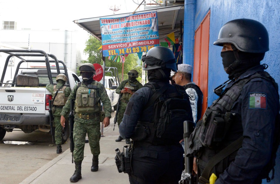 Mexican Army soldiers and state police at the scene where a leading journalist was executed last weekend