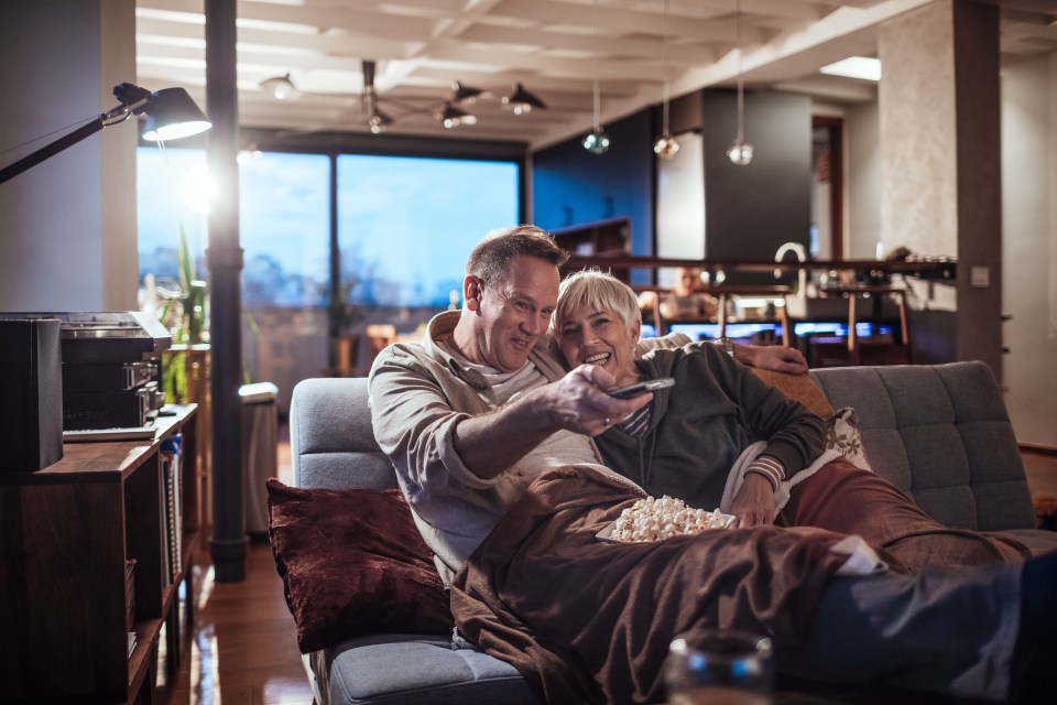 Close up of a mature couple watching a movie at home