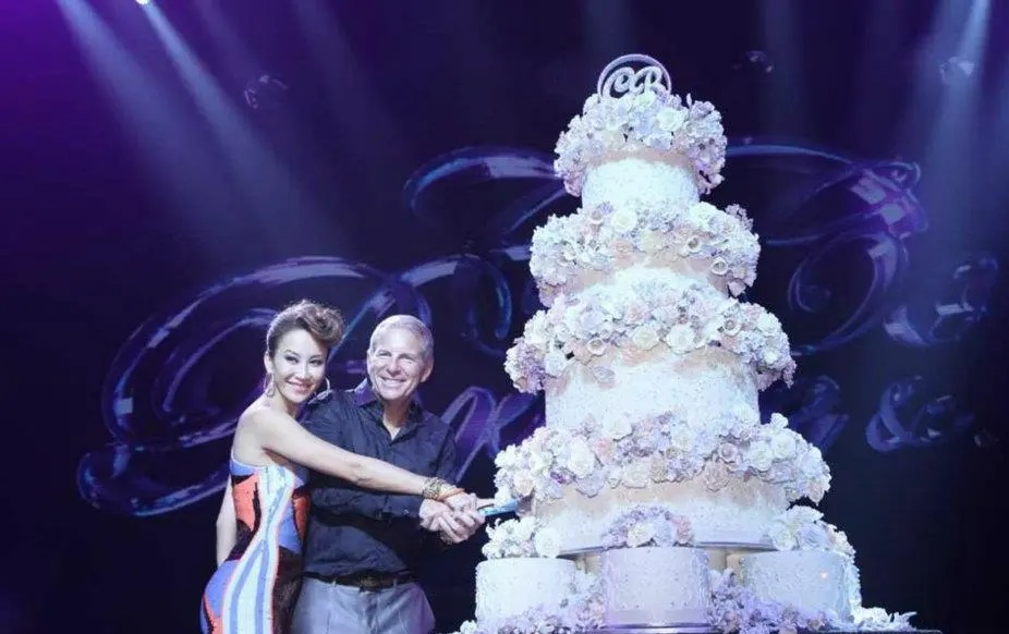 Coco and Bruce beamed as they cut their huge wedding cake