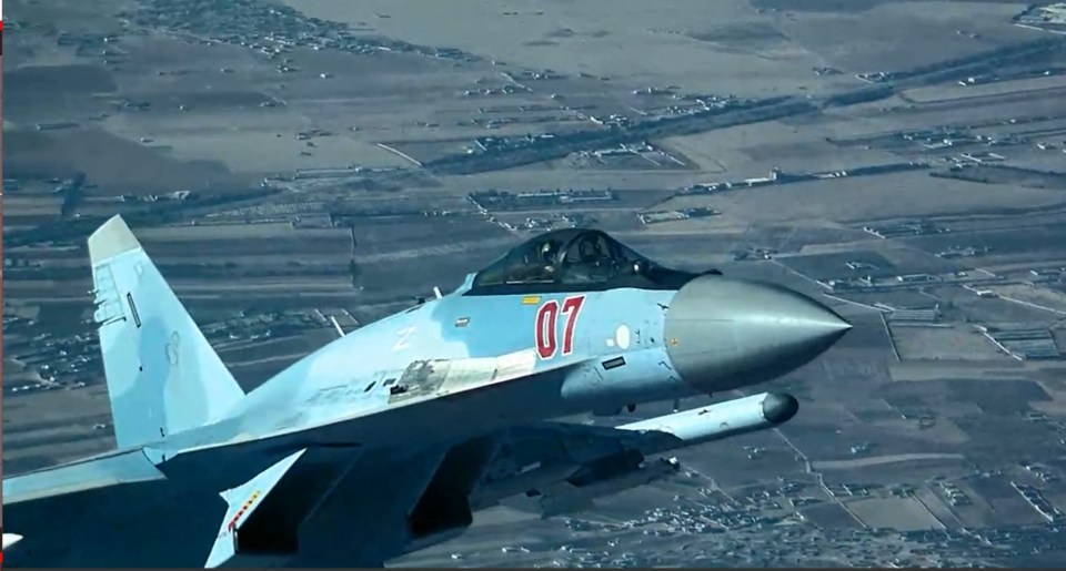 A Russian SU-35 is pictured flying dangerously close to a US drone in Syria