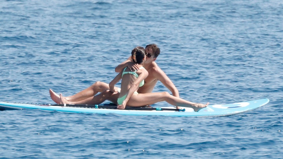 The couple had a smooch on a paddle surfing board