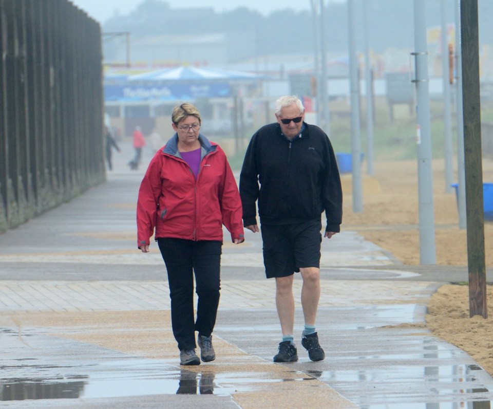 A couple battle the elements on Sandhaven Beach in South Shields, Tyne & Weir, on Monday morning