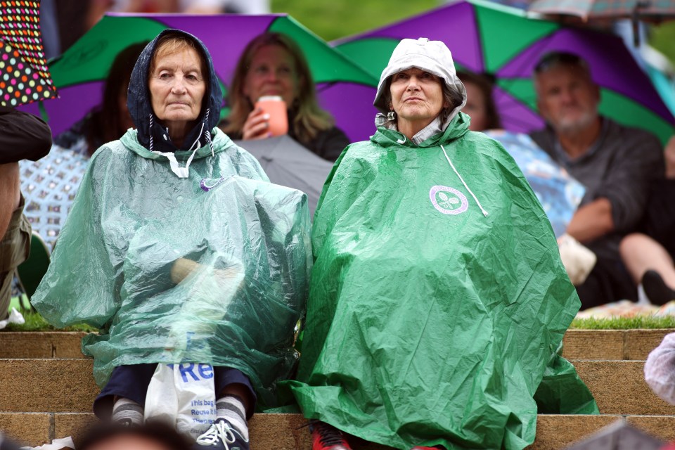 Wimbledon fans have used ponchos to protect themselves amid rainy weather today