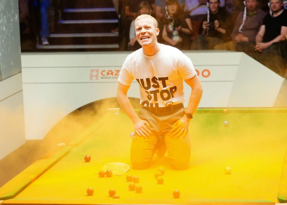 File photo dated 17-04-2023 of A Just Stop Oil protester after jumping on the table and throwing orange powder. Former World Snooker chairman Barry Hearn has called for tougher punishments for protesters after play was disrupted at the World Championship in Sheffield. Issue date: Tuesday April 18, 2023. PA Photo. See PA story SNOOKER World Protest. Photo credit should read Mike Egerton/PA Wire.