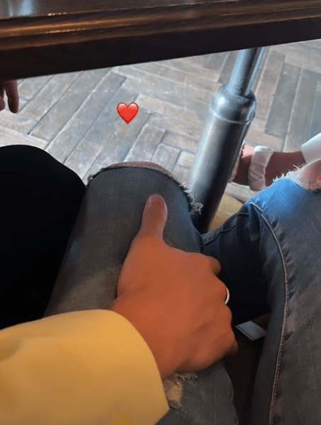 Harry Derbidge gets cosy with a mystery man under the table during a lunch date