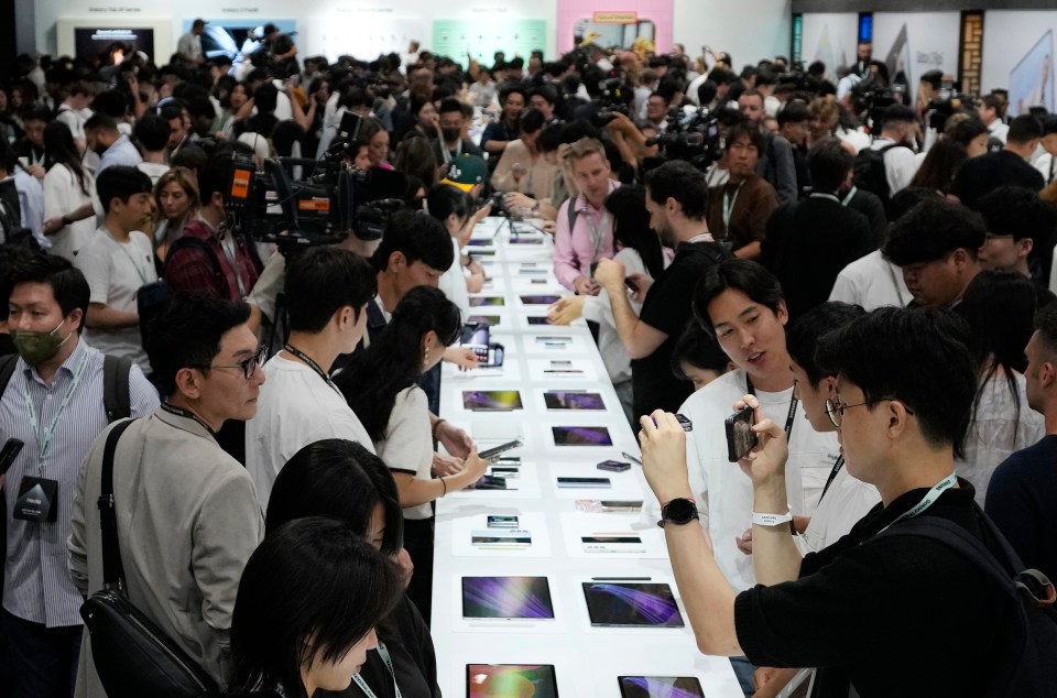 People look at products during the Galaxy Unpacked 2023 event at the COEX in Seoul, South Korea, Wednesday, July 26, 2023. Samsung Electronics on Wednesday unveiled two foldable smartphones as it continues to bet on devices with bending screens, a budding market that has yet to fully take off because of high prices. (AP Photo/Ahn Young-joon)