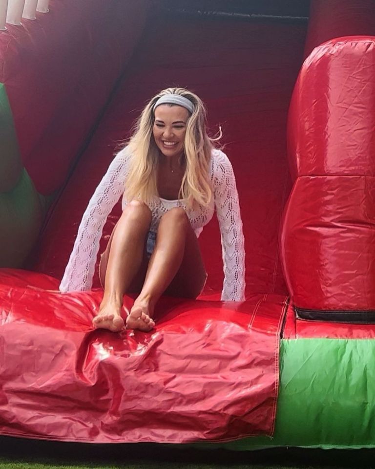 Christine embraced her inner child as she played with her kids on the bouncy castle