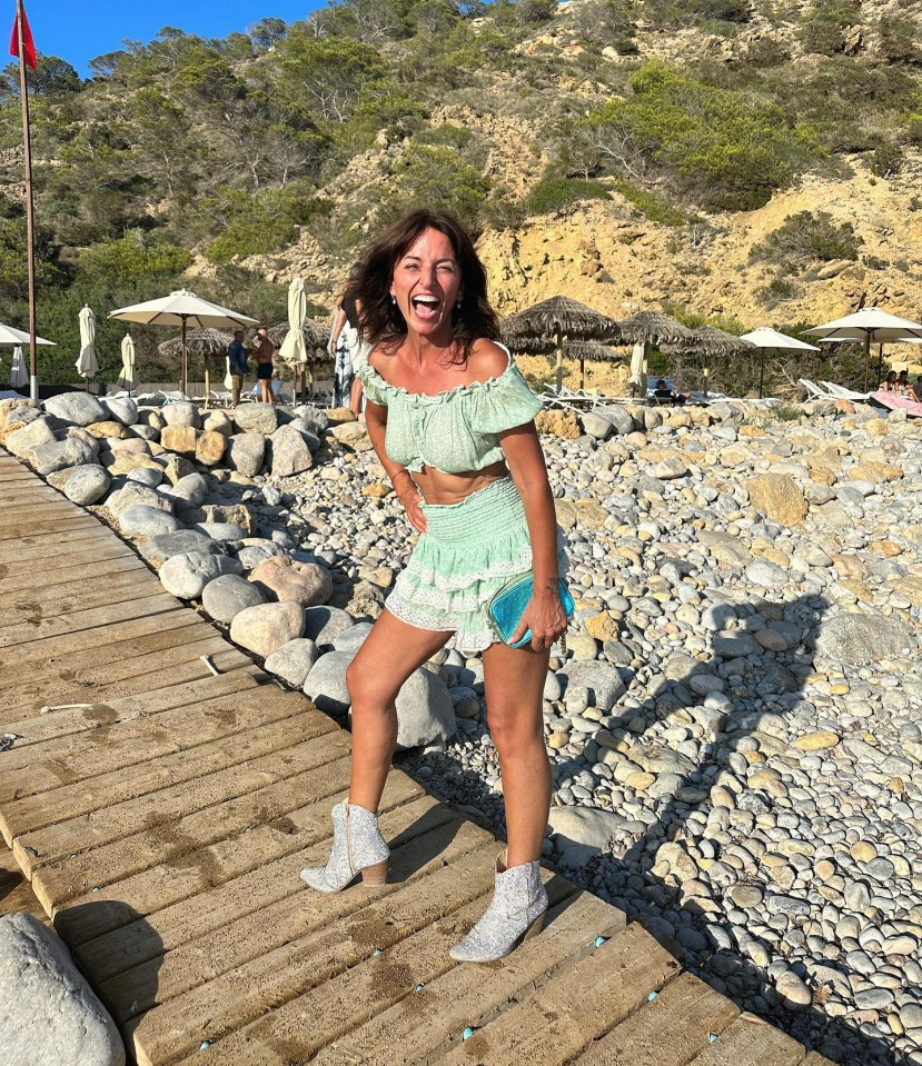 Davina McCall flashed her holiday tan in a mint green two-piece and a pair of sparkly cowboy boots