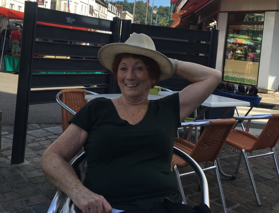 Joan, pictured on holiday in France, says she is still able to live independently thanks to the medication