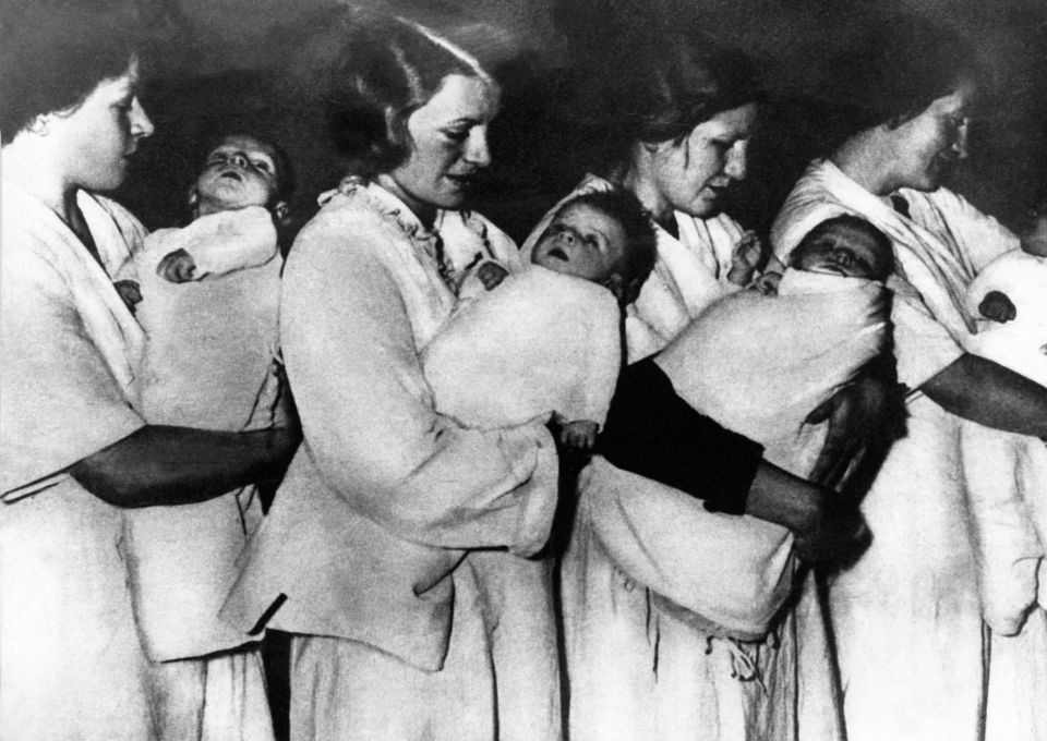 Women carry Lebensborn tots in a picture from 1937