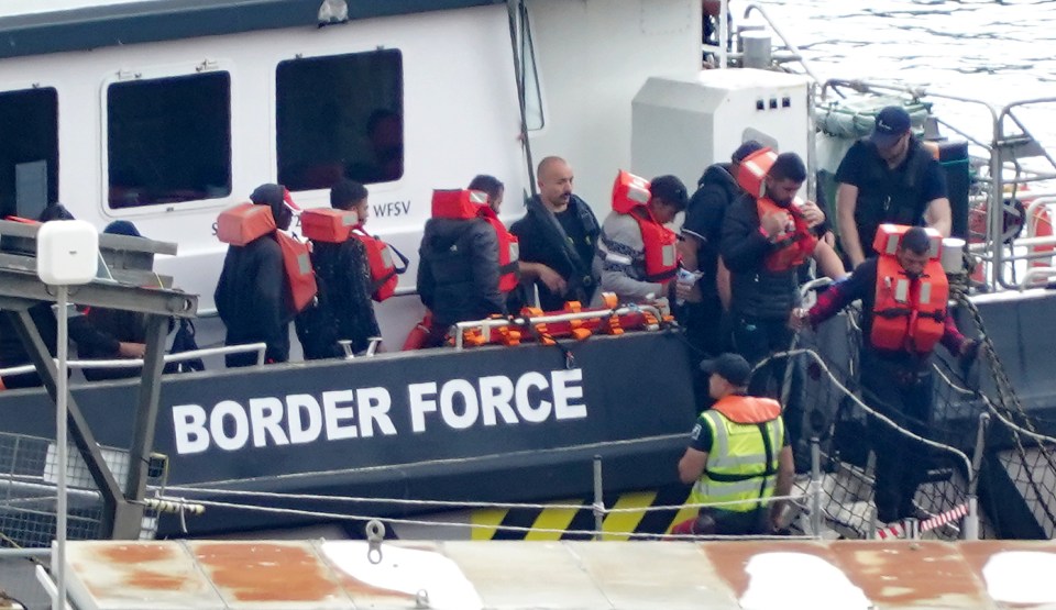 A group of migrants brought in to Dover, Kent, from a Border Force vessel after being rescued during a small boat incident in the Channel