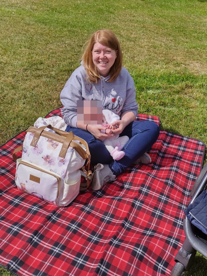 An NEU member on a picnic rug in the park