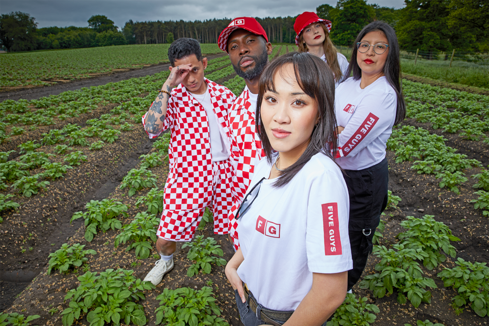 Five Guys restaurant staff model their new merchandise collection to celebrate