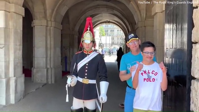 A King's Guard has been praised by a carer for breaking protocol to pose for a photo with a man with Down's syndrome