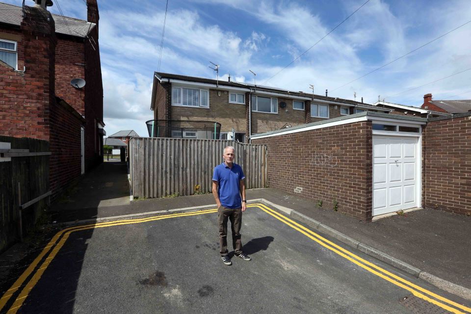 Tony Green looks glum as he stands in the new no-parking zones outside his house