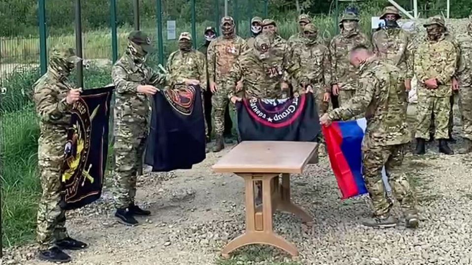 Soldiers took down the Russian flag before leaving the main Wagner camp in Russia today