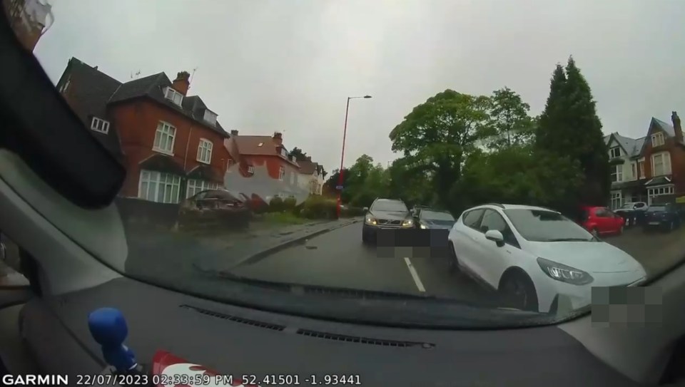 The driver nearly smashed into a car as they reversed back