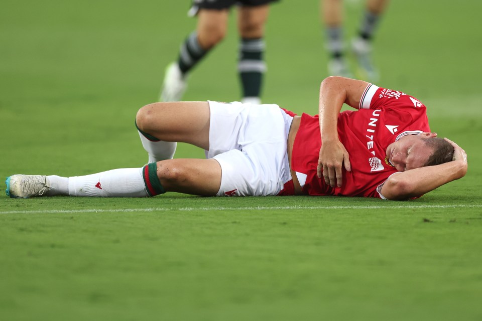 Paul Mullin on the ground after his collision with Manchester United goalkeeper Nathan Bishop