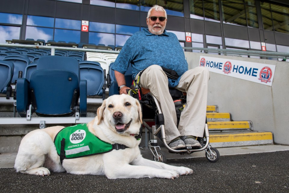 Paul Woodward, from Greater Manchester, says sport has “always been a passion” and having his dog Nita has made going to football more accessible