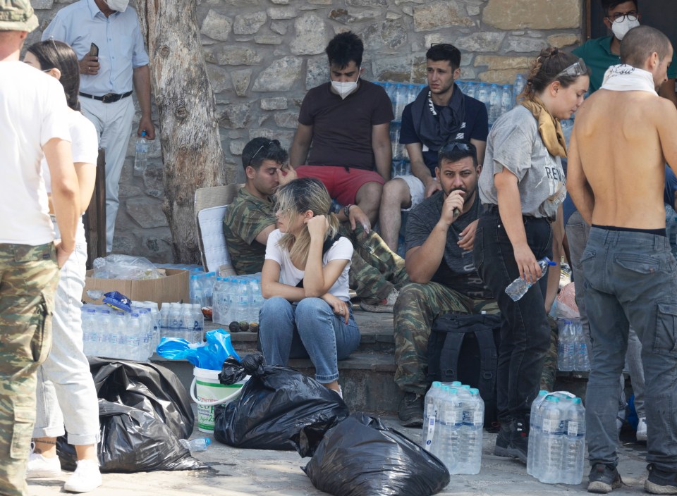 Exhausted emergency workers are seen resting