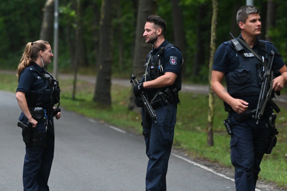 German cops with big guns scoured the area for the alleged 'lioness' into the night