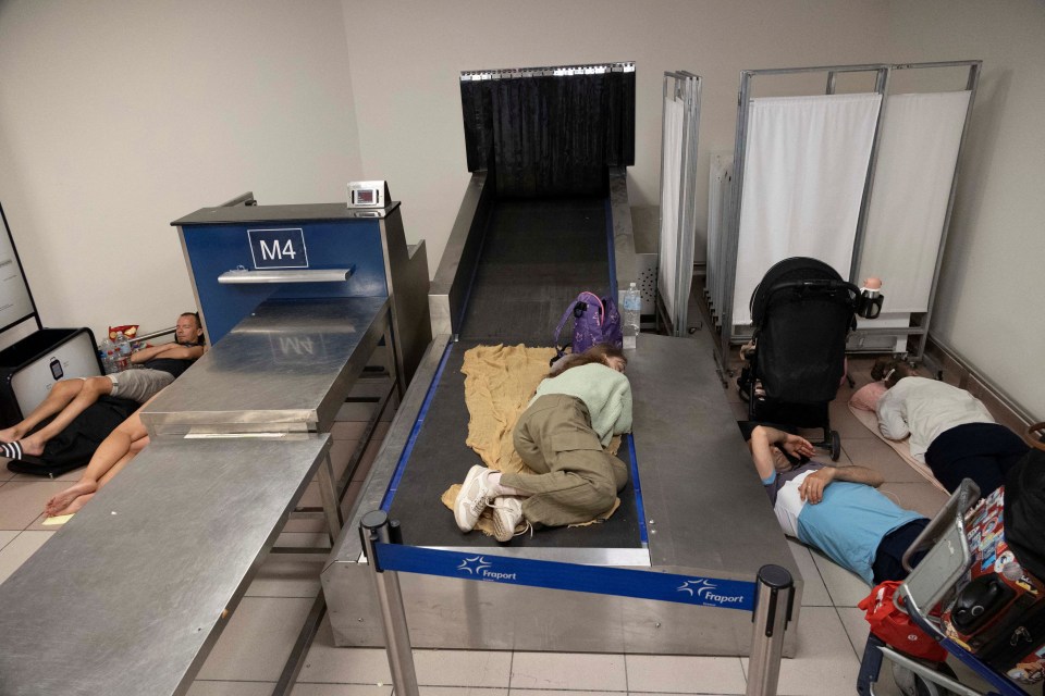 Tourists sleep at Rhodes airport as they wait to be evacuated