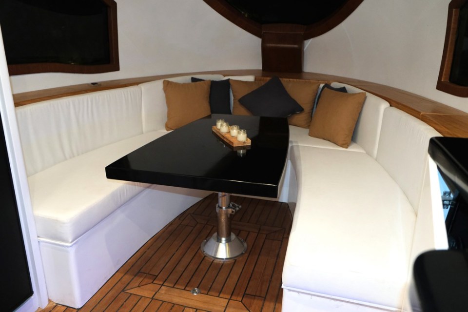 The lounge is located at the front of the vehicle and is fitted with a crescent-shaped seating area framed by a glass window