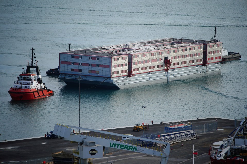 Tug boat Mercia pulls the Bibby Stockholm accommodation barge into Portland Port, where it is due to house illegal migrants after travelling from dry dock in Falmouth, Cornwall