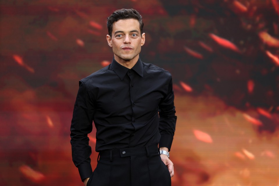 Rami Malek quickly posed for the cameras before rushing into the venue in Leicester Square