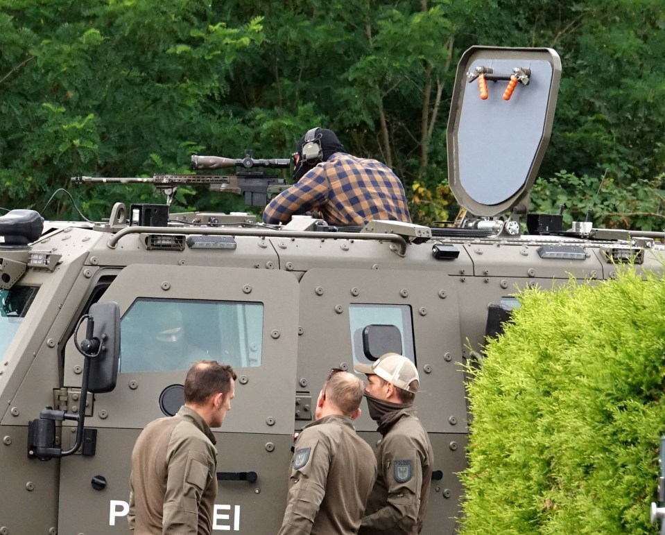 A sniper looked through their scoop on top of the armoured 'Survivor' as the 'lion hunt' continues