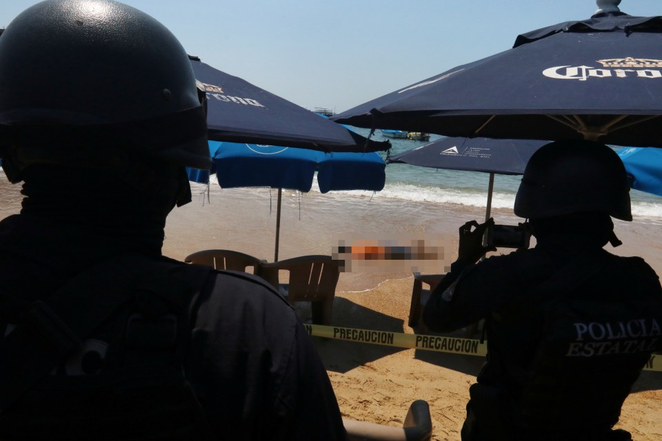 A bloody shooting victim lies face-down on the beach in 2018