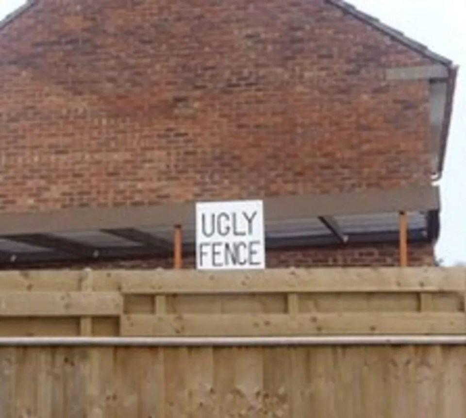 A sign made by Mr Bentley facing the Laws told them they had an 'ugly fence'