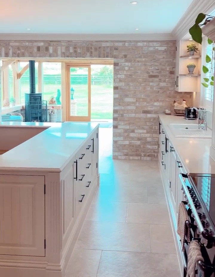 Her amazing kitchen leads into an Orangery they had built on