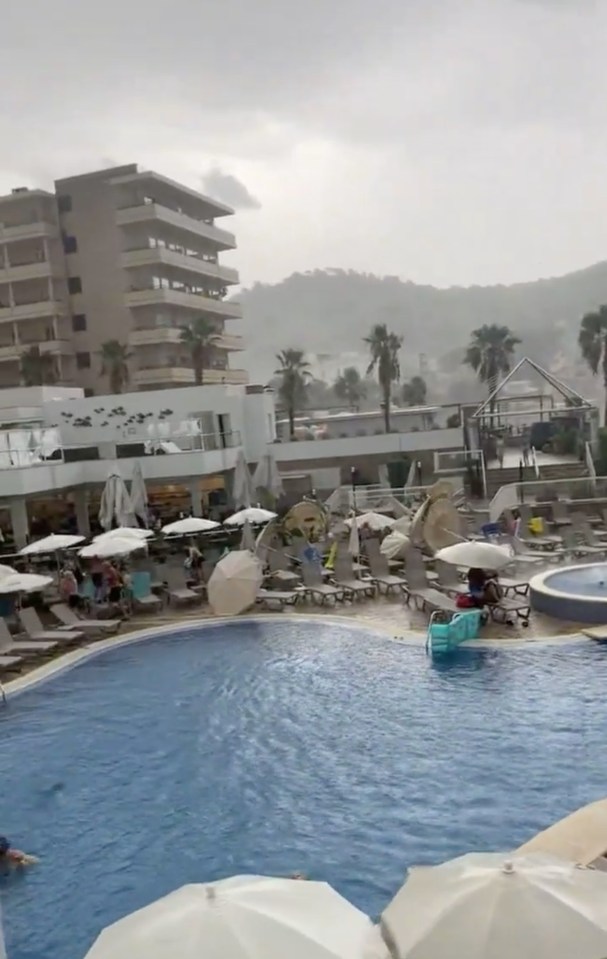 Parasols are blown over after storms hit Majorca