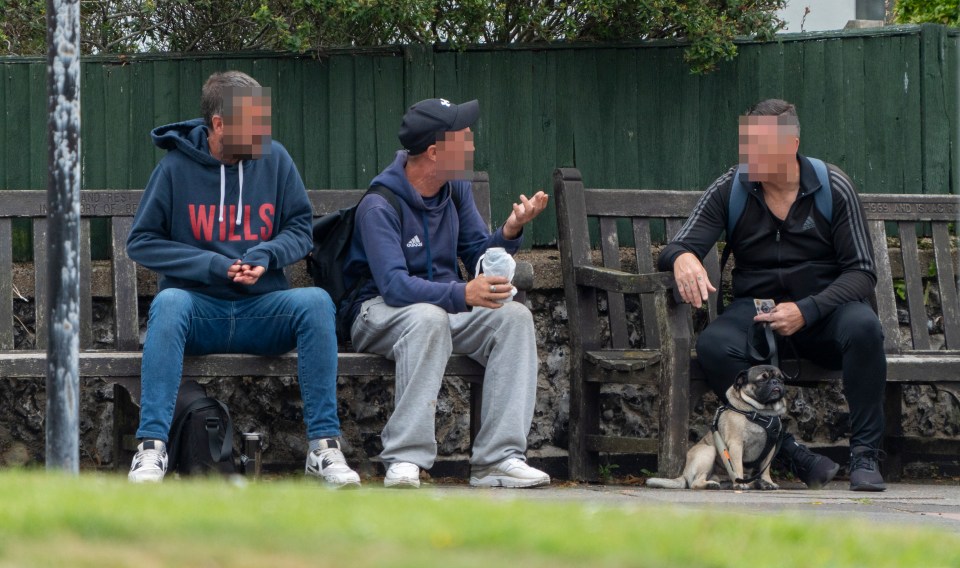 Locals chatting early morning, while one man gets stuck into a can of beer