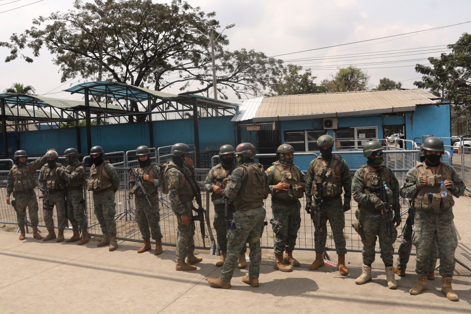 Soldiers stand guard at the Litoral Penitentiary after deadly clashes in Guayaquil