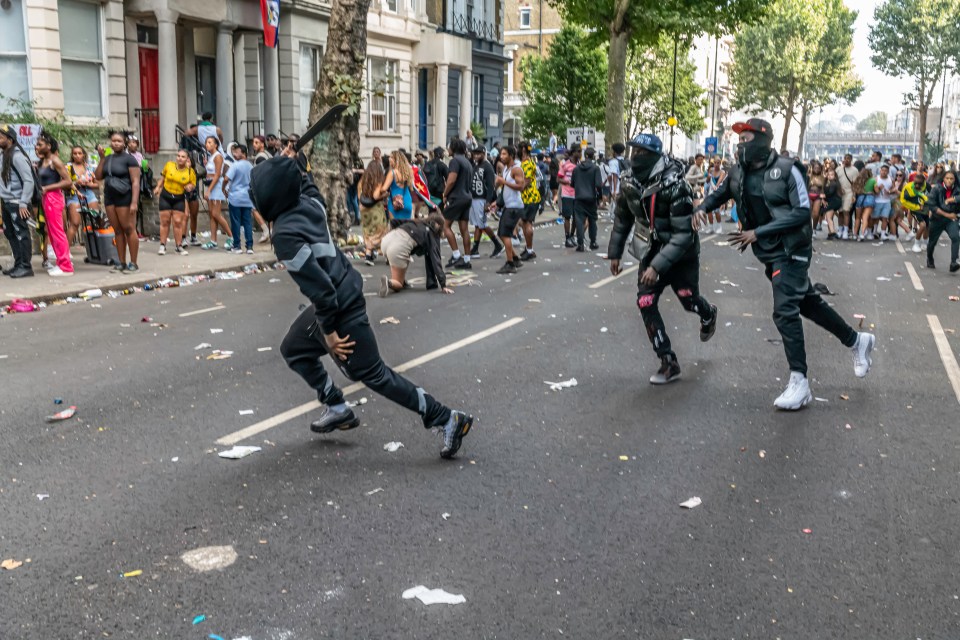 A boy with a huge machete running through Notting Hill Carnival