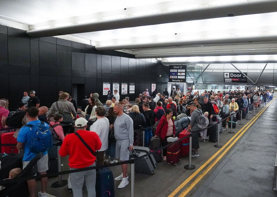 Passengers queue for check-in in the underground car park at Manchester Airport’s Terminal One