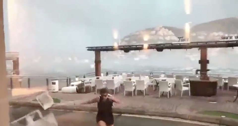 Tourists were forced to flee as deck chairs and parasols were blown away