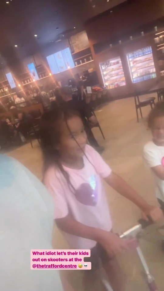 Her two daughters were filmed scooting around the retail destination