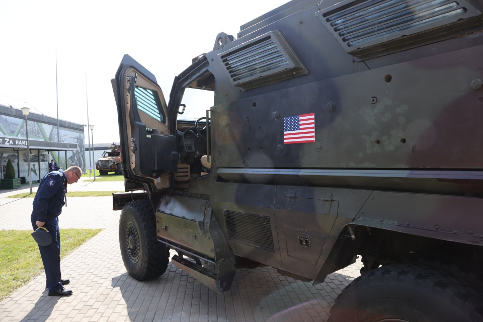 A Russian Army officer looks at an Armored Vehicle MaxxPro made in the US